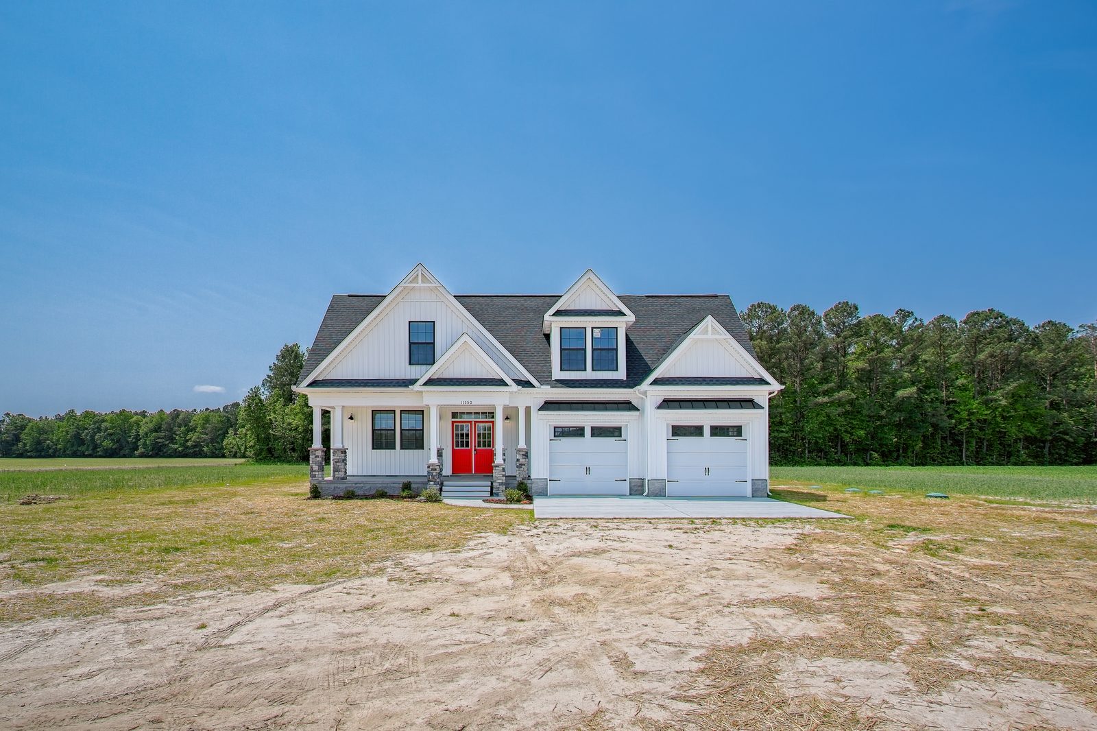 Front of a white two-story Emma home with a red door